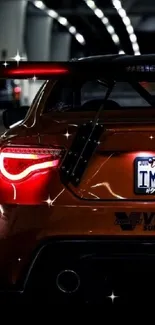 Orange sports car at night in a vibrant city setting.