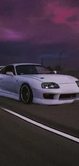 White sports car driving at night under a purple sky.