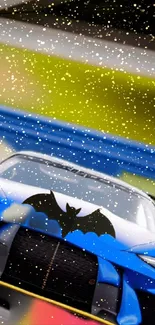 Sports car with bat logo in vibrant colors under snowfall.