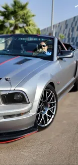 Silver convertible car parked outdoors with a stylish design.