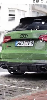 Rear view of a green Audi car on a street.