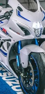 Sporty motorcycle with white and blue accents on display.