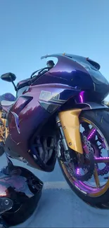 Sporty motorcycle with purple and gold accents on open road.