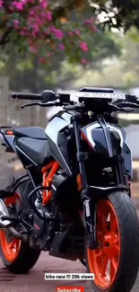 High-performance motorcycle with vibrant orange accents parked in sunlight.