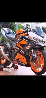 Vibrant orange motorcycle parked outdoors.