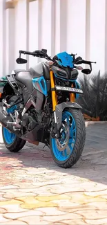 Sporty motorcycle with blue accents against white background.