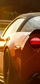 Vibrant orange sports car on a sunny road.