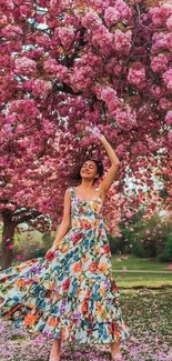 Woman in floral dress under cherry blossoms.