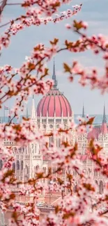 Cherry blossoms framing a cityscape with pink hues.