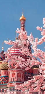 St. Basil's Cathedral with cherry blossoms under a blue sky.