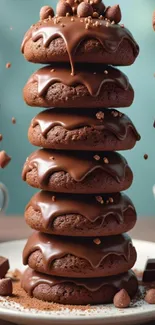 Stack of chocolate-covered donuts with dripping chocolate.
