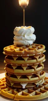 A stack of waffles with syrup and whipped cream, perfect for breakfast lovers.