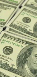 Close-up of stacked $100 bills wallpaper.
