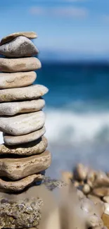 Stacked pebbles at the beach with ocean view.