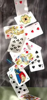 A creative stack of playing cards with dark wood background.