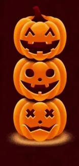 Stacked jack-o'-lanterns with spooky faces on dark background.