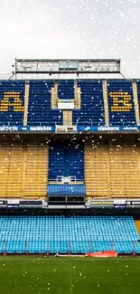 A vibrant stadium with blue and yellow bleachers in a wide view.