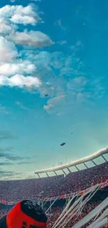 Crowd in stadium during sunset with vibrant sky and flowing streamers.