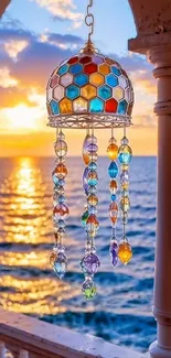 Stained glass art hanging with sunset ocean view.