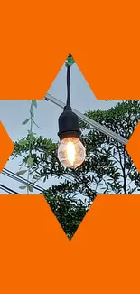 Orange star with light bulb over nature scene.