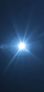 Radiant starburst light in a dark blue night sky.