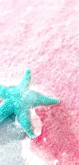 Turquoise starfish on a pink sandy beach wallpaper.