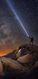 Adventurer under starry night sky with bright flashlight in cosmic landscape.