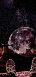 Person's view of a moonlit rocky landscape under a starry sky.