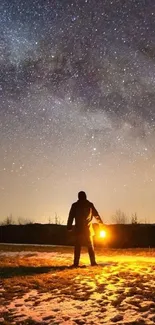 Silhouetted figure with lantern under a starry night sky.