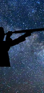 Silhouette of stargazer with telescope against a starry night sky.