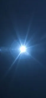 Dark blue wallpaper with a radiant star-like light in the center.