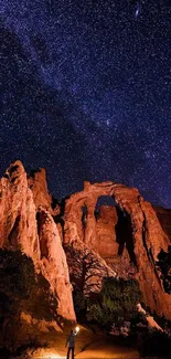 Majestic desert arch under a starry night sky.