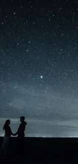 Couple silhouette holding hands under a starlit night sky.