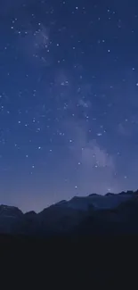 Serene dark blue starry night sky wallpaper with mountains.