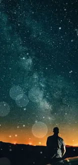 Silhouette under a starlit night sky with visible horizon glow.