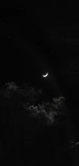 Crescent moon and clouds in a dark night sky.