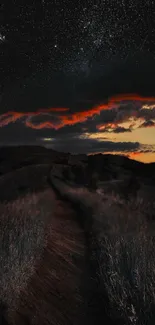 Starlit path under red clouds and night sky.