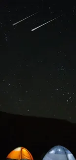 Two tents under a starry sky with shooting stars in the night.