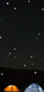 Starry night sky with tents illuminated under starlight.