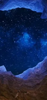 Starry night sky through cave opening wallpaper.