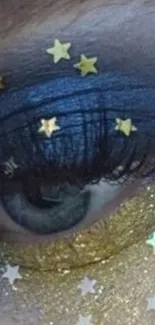 Close-up of eye with blue makeup and star design.