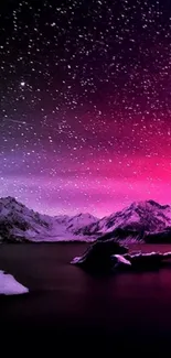 Starry night sky over mountains with a magenta glow.