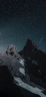 Starry night sky over rugged mountains.