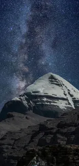 Starry night sky over a snow-capped mountain peak in a serene nightscape.