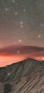 Starry mountain sunset with glowing sky and snowy peaks.