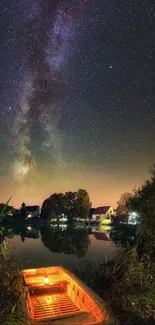 Starry night sky reflected on lake with lit boat on shore.