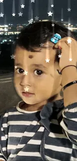 Child's portrait under starry night sky with city lights.