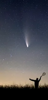 Silhouette against starry night sky with visible comet trail.