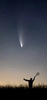 Silhouette watching comet in starry night.