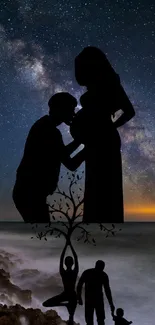 Silhouette of family under starry sky with ocean view and Milky Way backdrop.